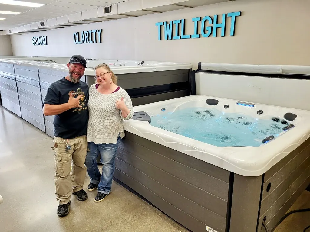 Paradise Spas customers next to the hot tub they picked out