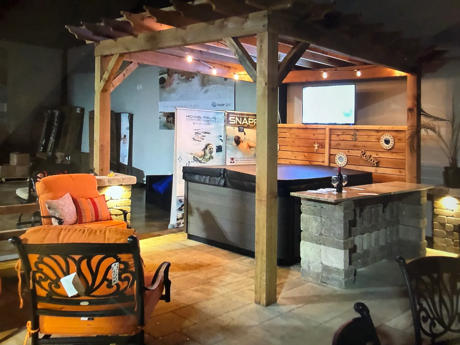 Outdoor living display with a pergola and hot tub in the Williston store